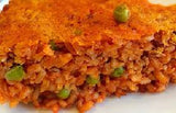 Timballo di riso al sugo con funghi e piselli