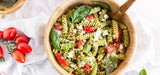 Fusilli integrali con pesto, pomodorini rossi e surimi